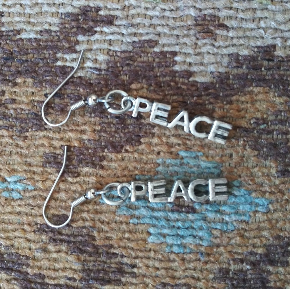 Never worn PEACE silver dangle earrings